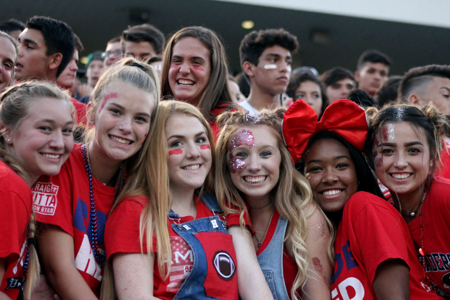 Savannah Baldwin, third from the right, shows her school spirit during the first football game of the season.