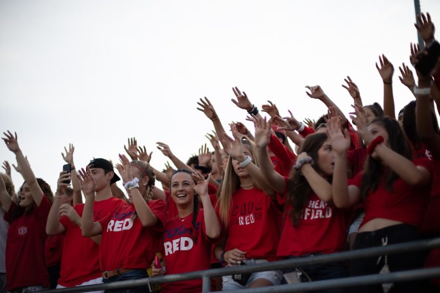 The Ryan High School student section, Code Red, cheers on the varsity football team during kickoff of the game against Mesquite Poteet High School. 